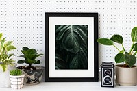 Picture frame mockup psd among houseplants home decor