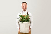 Small business owner holding plants in sustainable packaging