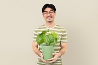 Asian plant lover mockup psd holding potted Calathea Orbifolia