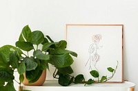 Picture frame mockup psd next to jade pothos houseplants home decor