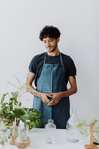 Man water propagating his houseplants