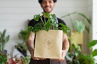 Shopping bag mockup psd with plant inside eco-friendly shop