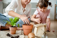Kid potting plant at home as a hobby
