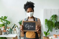 Blackboard sign mockup psd with plant shop owner new normal business