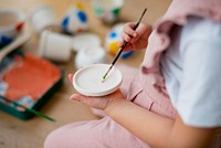 Happy kid at home DIY pot painting hobby