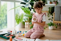 Kid painting a plant pot home diy hobby