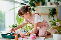 Little girl pot painting at home