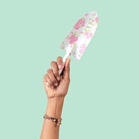 Hand mockup psd holding floral patterned shovel gardening tool