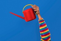 Hand mockup psd holding red watering can gardening tool