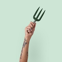 Gardening tool hand fork held by a woman's hand