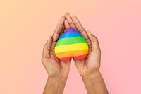 LGBTQ+ community heart with hands presenting