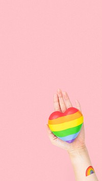 LGBTQ+ community heart with hands presenting