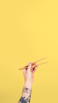 Hand holding chopsticks for food concept