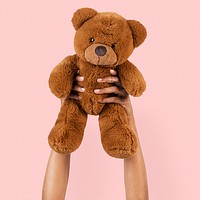 Teddy bear toy mockup psd held by a hand for kids