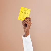 Covid-19 vaccine certificate mockup psd held by a businessman’s hand