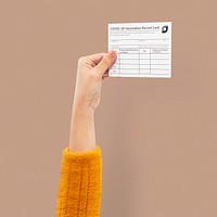 Covid-19 vaccine certificate mockup psd held by a businessman&rsquo;s hand