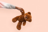 Teddy bear mockup psd held by a hand for charity campaign