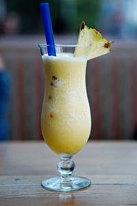 Slice of pineapple on a pineapple juice cocktail. Original public domain image from Wikimedia Commons
