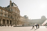 People walking outside the Louvre Museum in Paris. Original public domain image from Wikimedia Commons