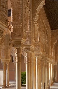 Columns, arches and capitals in Lions Palace of Alhambra, Granada, Spain. Original public domain image from <a href="https://commons.wikimedia.org/wiki/File:Patio_de_los_leones_colonnes.jpg" target="_blank">Wikimedia Commons</a>