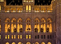 Detail of the facade of the new City Hall, (1872-1883), evening light. Original public domain image from <a href="https://commons.wikimedia.org/wiki/File:Detail_fa%C3%A7ade_neues_Rathaus_Vienna_night.jpg" target="_blank" rel="noopener noreferrer nofollow">Wikimedia Commons</a>