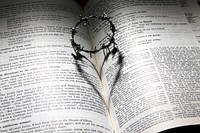 Crown of thorns forms a heart in an open Bible. Original public domain image from Wikimedia Commons