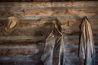 Coats and a cowboy hat at the &quot;Hole-in-the-Wall&quot; Cabin at Old Trail Town, a historic museum complex in Cody, Wyoming.