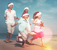 Family running on the beach in Christmas.