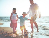 Family playing on the beach.