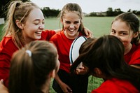 Cheerful girl’s rugby team talking after the game