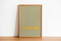 Wooden picture frame mockup psd leaning against the wall home decor
