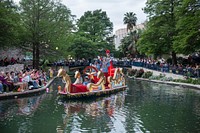 Scene from the Texas Cavaliers River Parade on the San Antonio River, which winds through the River Walk beneath the streets of San Antonio, Texas.
