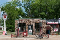 An old gas station (converted to a motorcycle shop) in Jefferson, a town in Marion County in East Texas on whose main street almost every commercial building, and many nearby homes, have a historic marker.