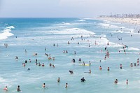 People swimming in the ocean, Praia Huntington, California. Original public domain image from Wikimedia Commons