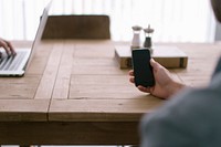 A display of smartphone technology device and laptop on a wooden table. Original public domain image from Wikimedia Commons