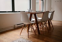 An interior of a meeting room stocked with modern wooden chairs and table in an office space. Original public domain image from <a href="https://commons.wikimedia.org/wiki/File:Chairs_in_a_meeting_room_(Unsplash).jpg" target="_blank" rel="noopener noreferrer nofollow">Wikimedia Commons</a>