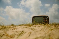 Retro TV on a beach. Original public domain image from <a href="https://commons.wikimedia.org/wiki/File:Cabo_Polonio_(Unsplash).jpg" target="_blank">Wikimedia Commons</a>