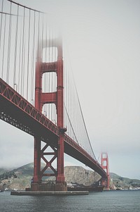 Golden Gate Bridge disappears into the clouds by the bay. Original public domain image from <a href="https://commons.wikimedia.org/wiki/File:Fog_Over_The_Bay_(Unsplash).jpg" target="_blank" rel="noopener noreferrer nofollow">Wikimedia Commons</a>