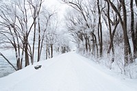 Snow-covered road by the frozen river in Winter. Original public domain image from Wikimedia Commons