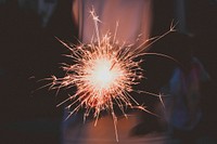 A sparkler burning at night. Original public domain image from Wikimedia Commons