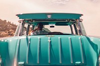 Man sitting in stylish teal classic car looking out window during daytime. Original public domain image from <a href="https://commons.wikimedia.org/wiki/File:Man_sitting_in_teal_car_(Unsplash).jpg" target="_blank" rel="noopener noreferrer nofollow">Wikimedia Commons</a>