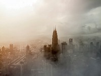 Tall skyscrapers in Kuala Lumpur wreathed in a dense fog. Original public domain image from Wikimedia Commons