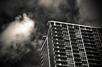 Black and white shot of urban condo apartment building from below with clouds, Orlando. Original public domain image from Wikimedia Commons
