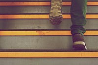A person's feet on gray and yellow stairs. Original public domain image from Wikimedia Commons