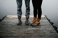 Impermeable shoes worn by a young couple standing on a pier. Original public domain image from Wikimedia Commons