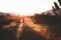 Men walking to the sun on a field. Original public domain image from Wikimedia Commons