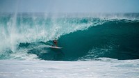 A surfer riding a board as a wave begins to crest in the blue ocean at Sunset Beach. Original public domain image from Wikimedia Commons