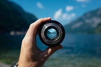 Camera lens against blue lake. Original public domain image from Wikimedia Commons