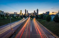 A long-exposure shot of a freeway leading into the city with red and yellow light trails. Original public domain image from Wikimedia Commons