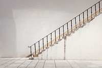 A side shot of old white stairs with a black bannister. Original public domain image from Wikimedia Commons